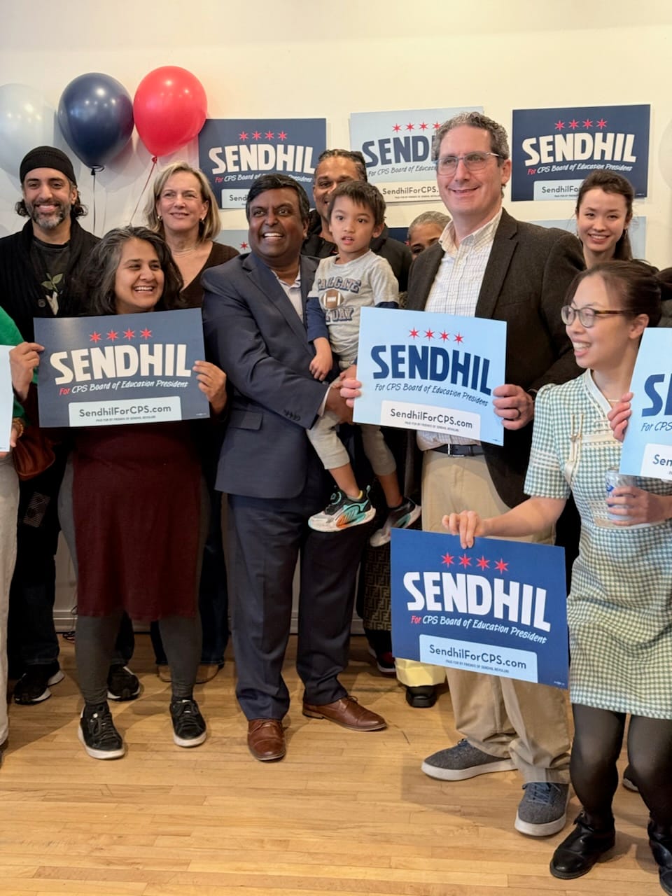 Supporters surround Sendhil Revuluri, who is running for president of the Chicago Board of Education.