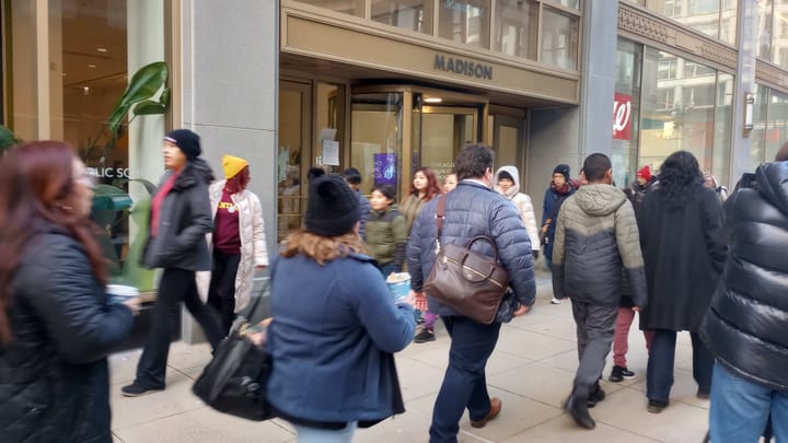 People march in a circle in front of the Chicago Public Schools offices.