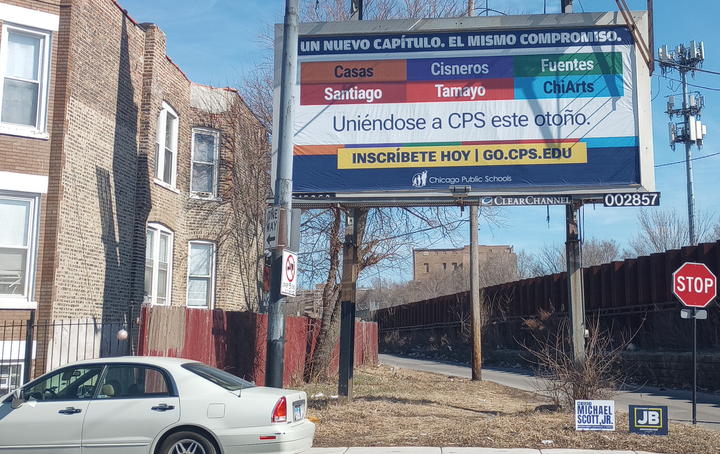 A Spanish-language billboard encourages families to enroll their children in Casas, Cisneros, Fuentes, Santiago, Tamayo, or ChiArts.